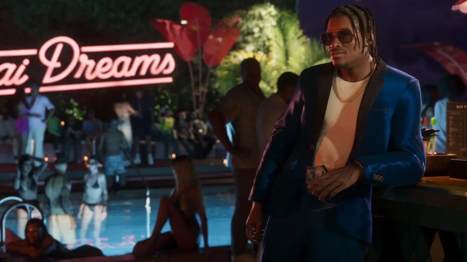 Dre'Quan Priest en costume, accoudé à un bar lors d'une soirée au bord d'une piscine.