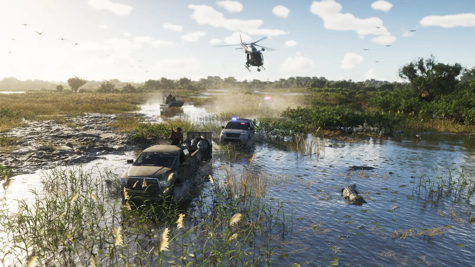 Un hélicoptère et deux voitures de police poursuivent un pick-up dans un marais des Grassrivers.